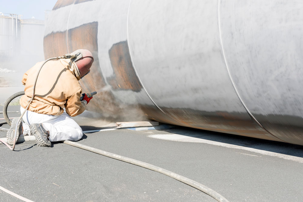 Sandblasting pipe surface preparation for industrial equipment finishing