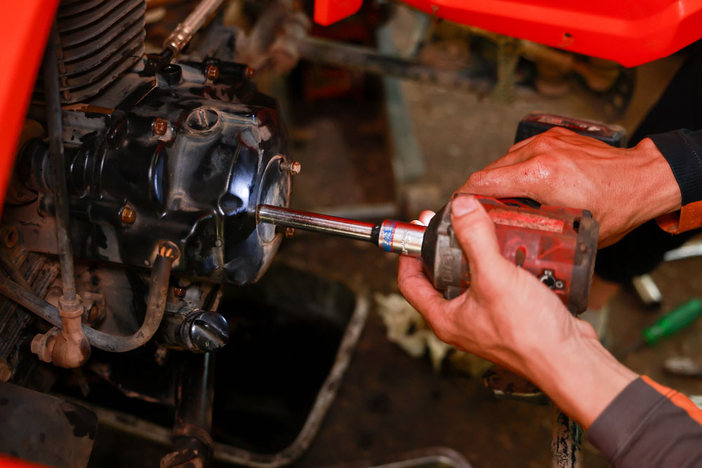 Technician performing repairs on construction vehicle components